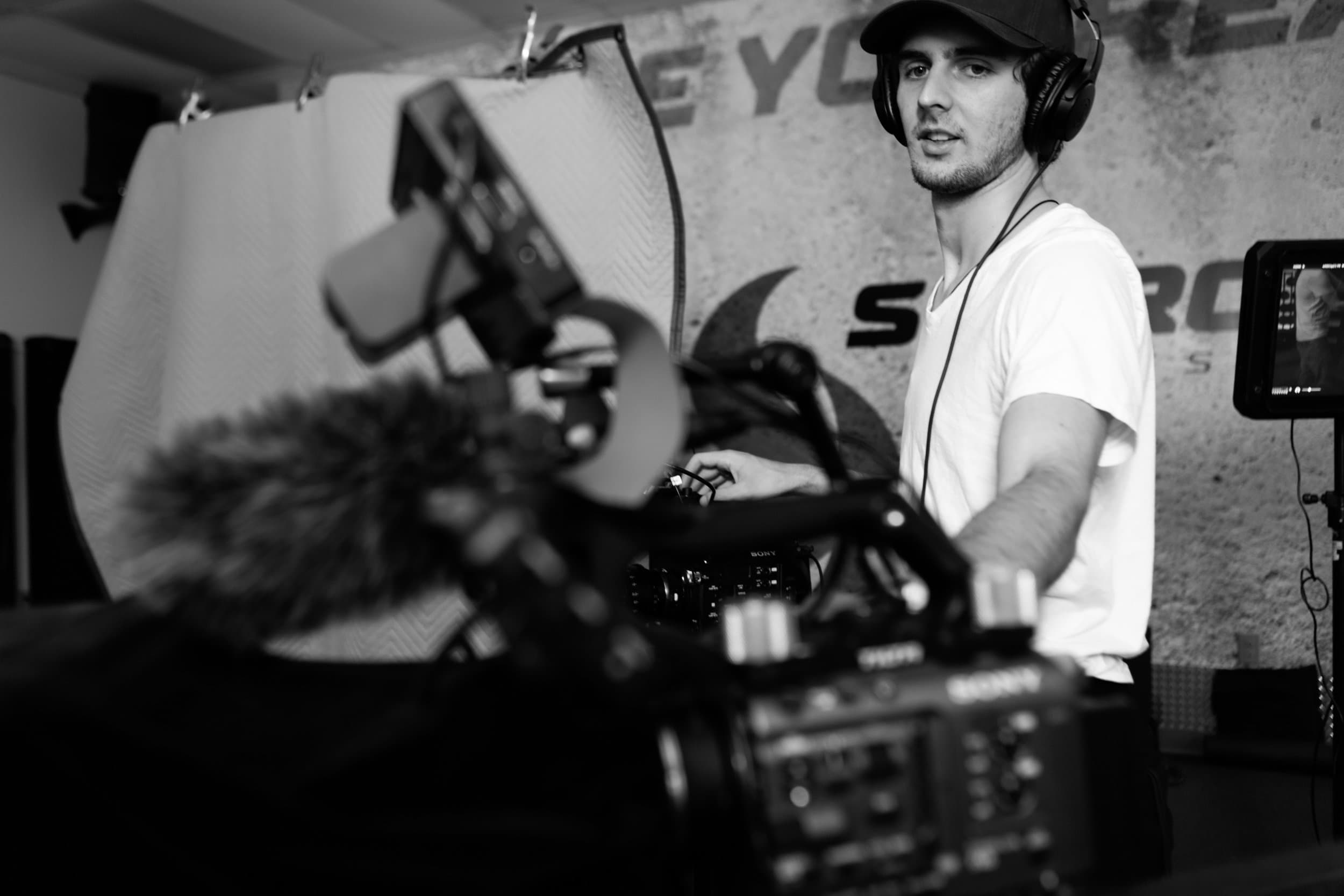 Caleb Duplain operating a cinema camera on set