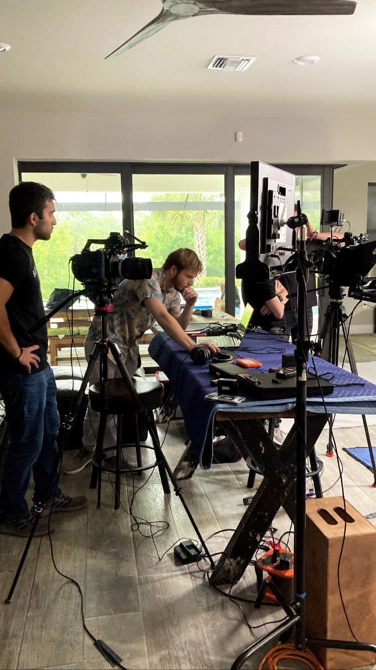 Crew and client at a table with the camera rolling