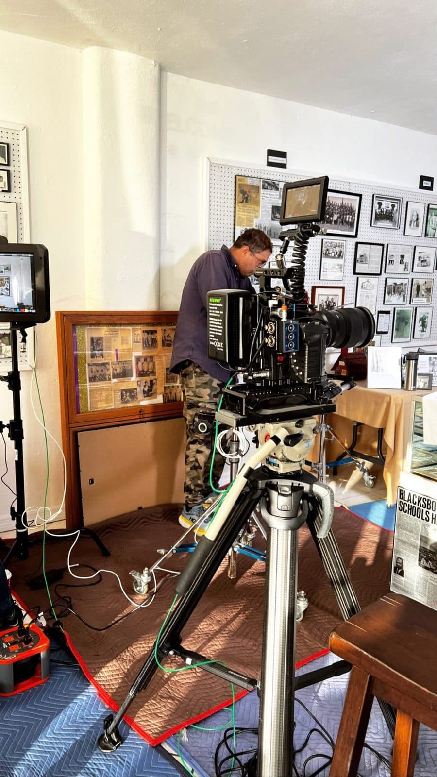 Interview setup in a room full of framed photos