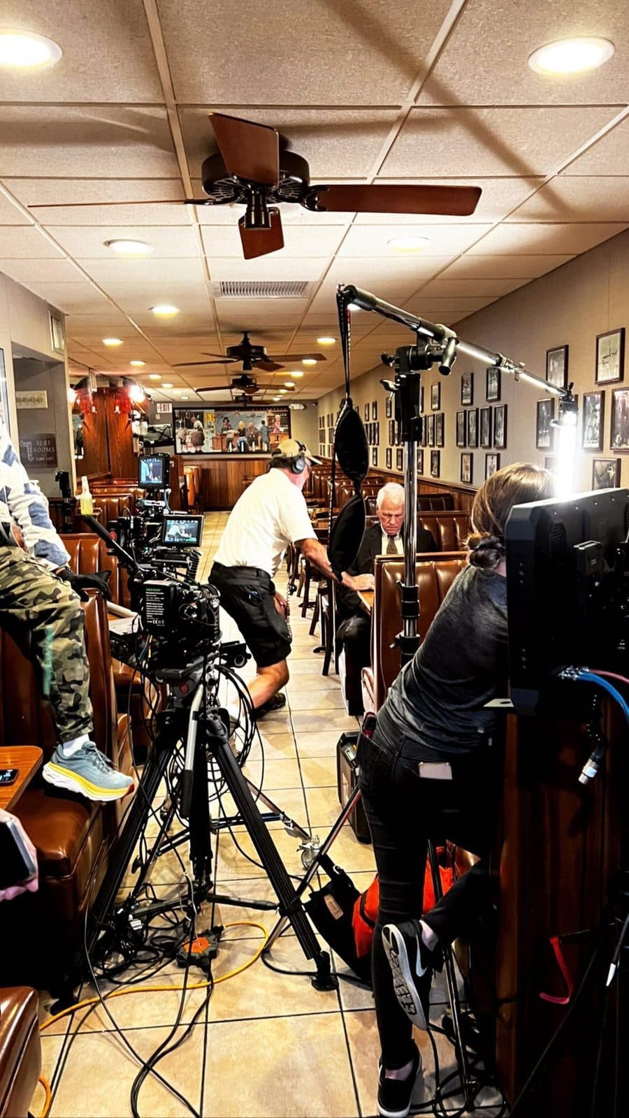 A crowded set with lights and two cameras